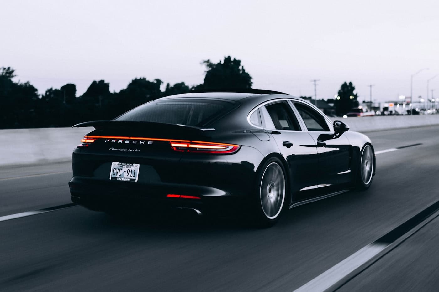 Gloss reflection down the side of a dark sedan